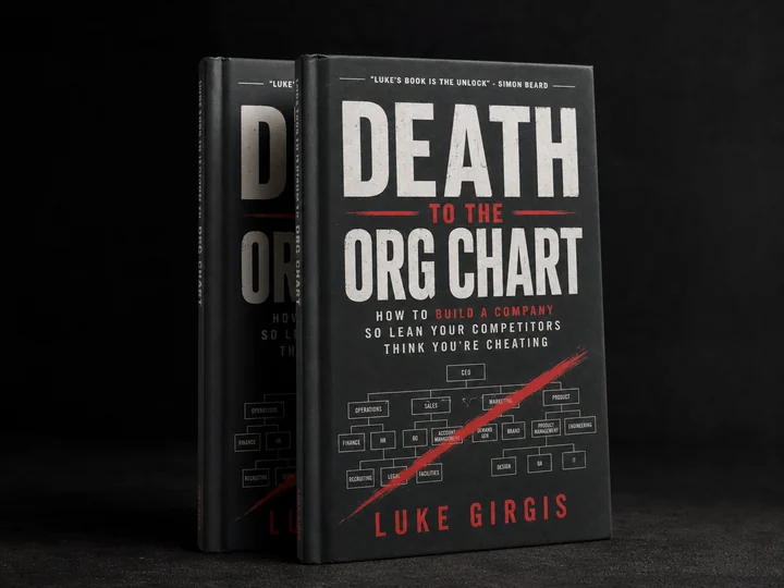 Two casebound hardcover copies of Death to the Org Chart in a dark editorial studio portrait